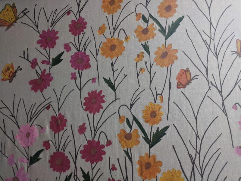 a wallpaper with flowers and butterflies on a wall at Pension Irene in Sougia