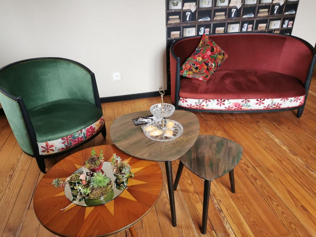 salon z 2 krzesłami, stołem i kanapą w obiekcie L'en vert appartement w mieście Bagnères-de-Bigorre