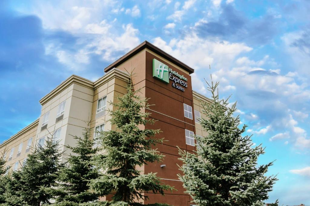 a hotel with a sign on the side of a building at Holiday Inn Express & Suites Spruce Grove - Stony Plain by IHG in Spruce Grove