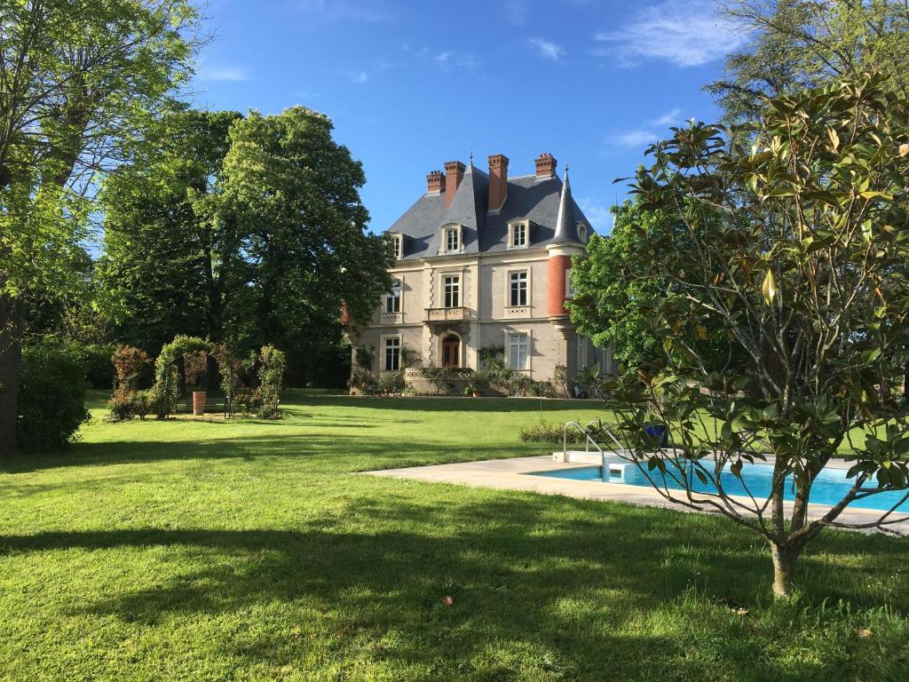 a large house with a swimming pool in the yard at Domaine du Perrier in Sainte-Agathe-la-Bouteresse