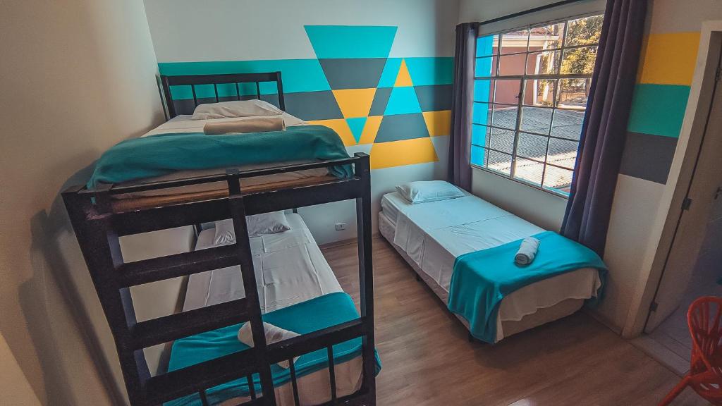 Postel nebo postele na pokoji v ubytování Social Hostel Café e Bar