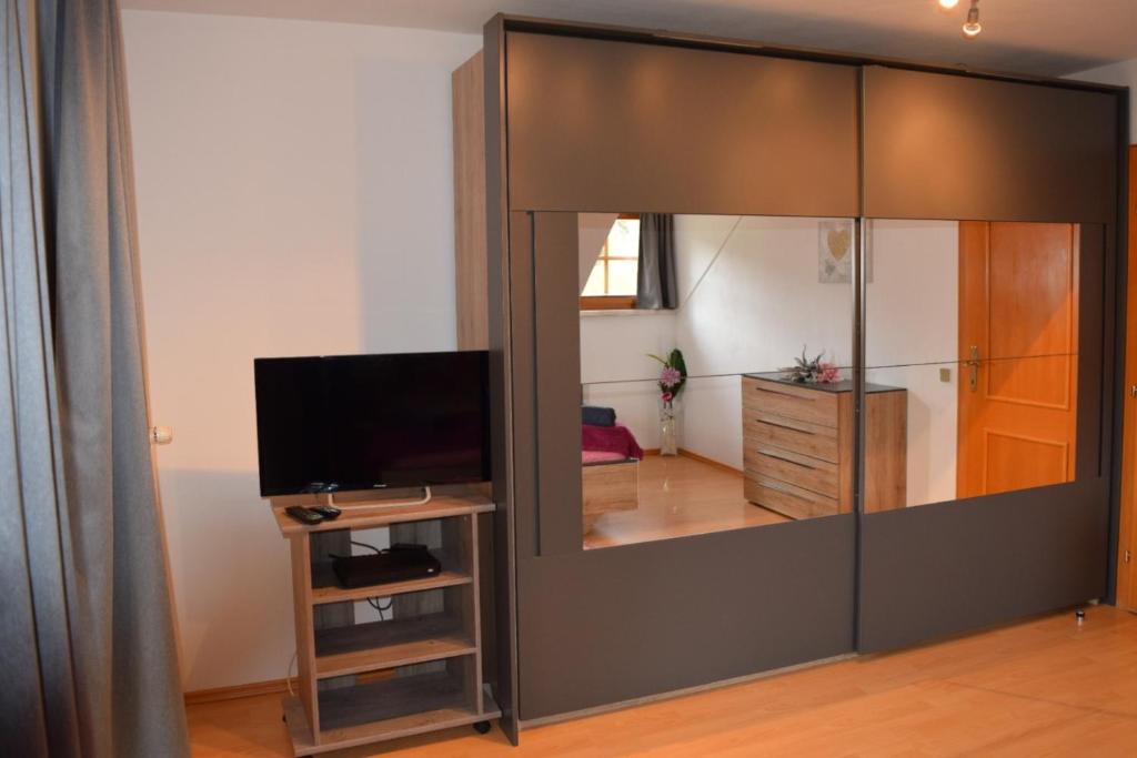 a large mirror in a living room with a television at Ferienwohnung Familie Pichler in Neumarkt in Steiermark