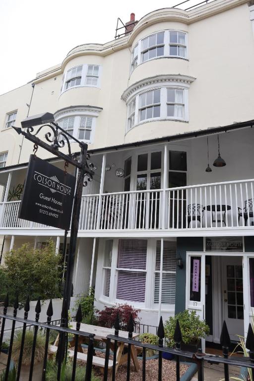 a white building with a sign in front of it at Colson House in Brighton & Hove