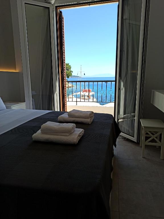 a bedroom with a bed and a view of the ocean at PS HOUSE Old Port - PS Rental in Skiathos