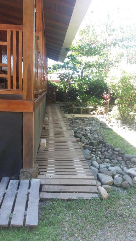 a wooden bench sitting on top of a wooden walkway at Kelly Creek Hotel in Puerto Limón