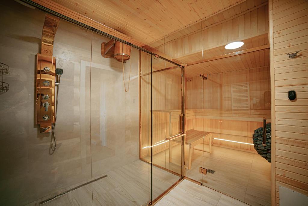a shower with a glass door in a room at "Шале Олень" in Yablunytsya