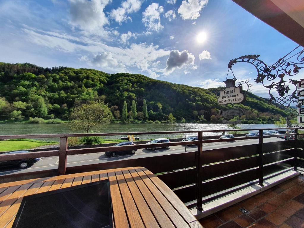 a view of a river with cars on a bridge at Römerstube Apartments & rooms in Ediger-Eller