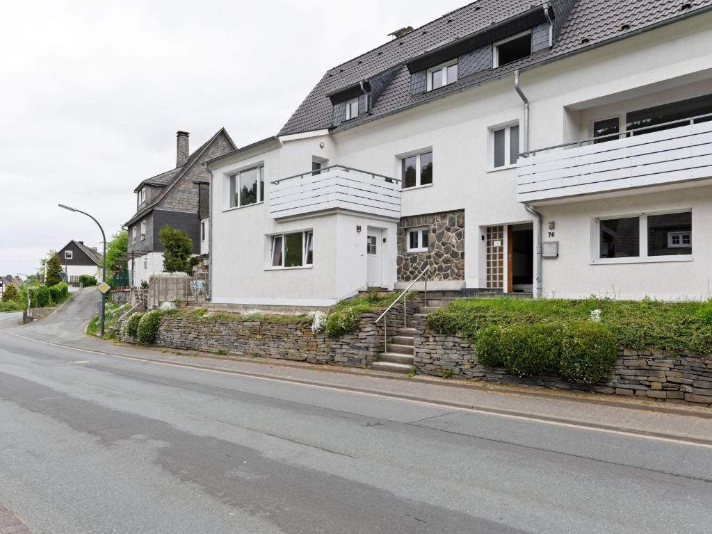 a white house on the side of a street at Beautiful Holiday Home in Winterberg near Ski Slopes in Winterberg