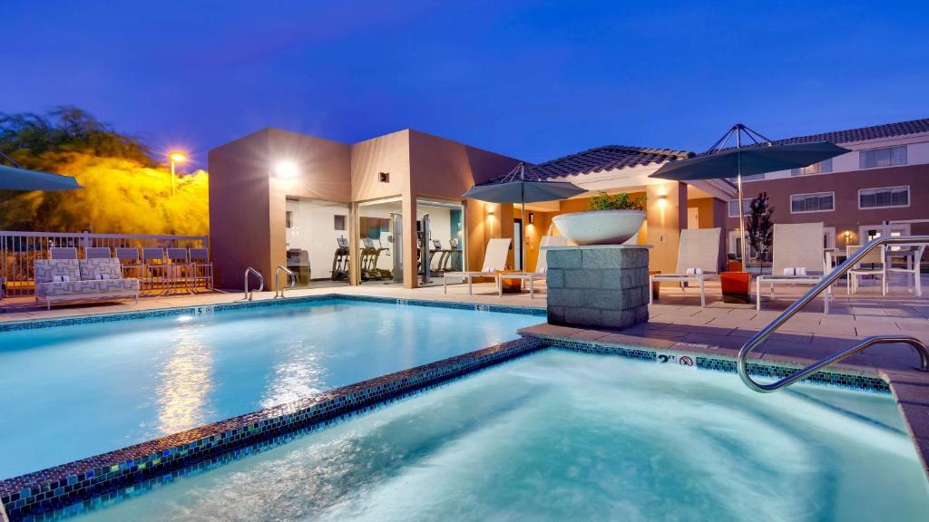 a swimming pool in front of a house at Aiden by Best Western Scottsdale North in Scottsdale
