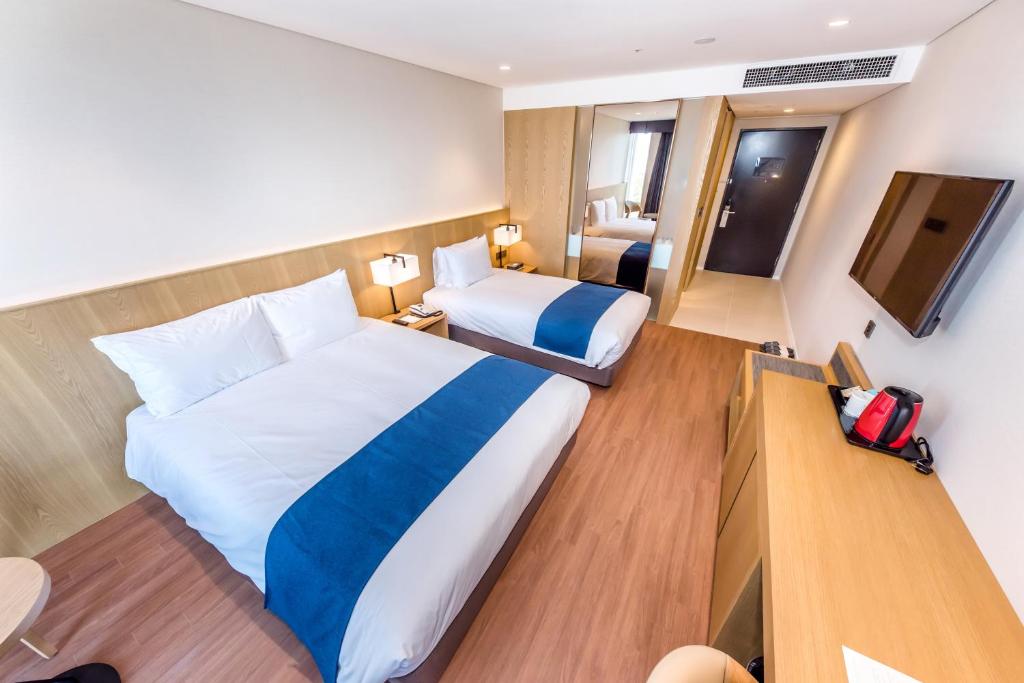 Postel nebo postele na pokoji v ubytování Hotel Sirius