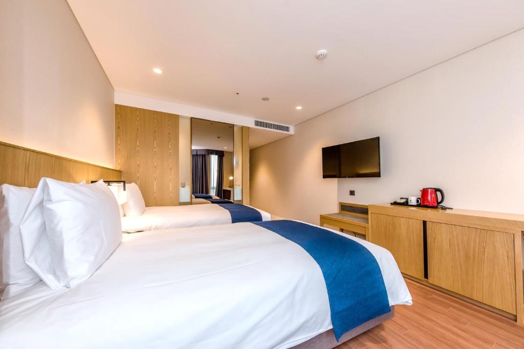 Postel nebo postele na pokoji v ubytování Hotel Sirius
