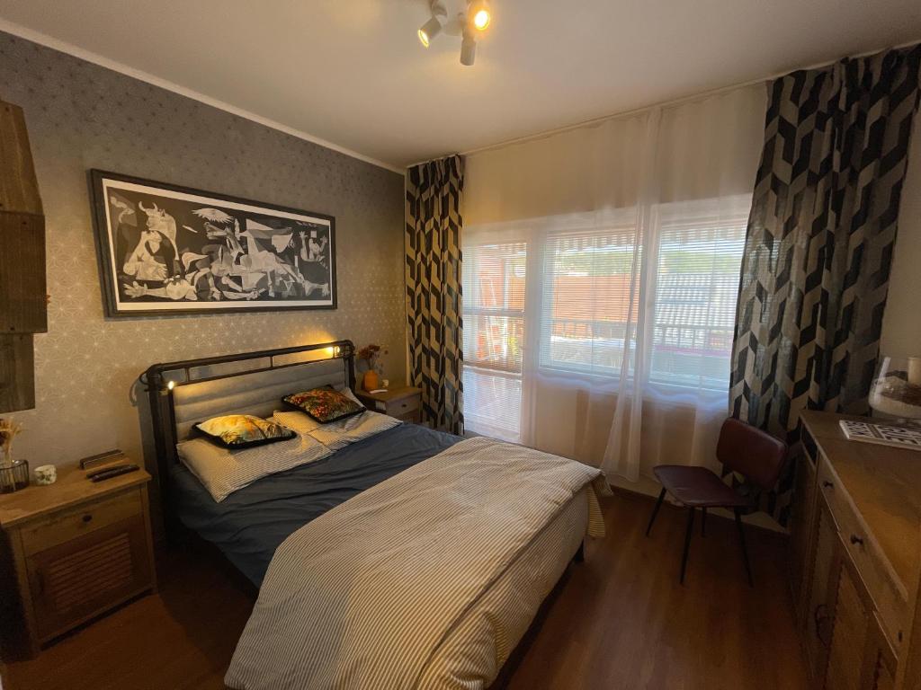 a small bedroom with a bed and a window at Andel Studio with terrace in Prague
