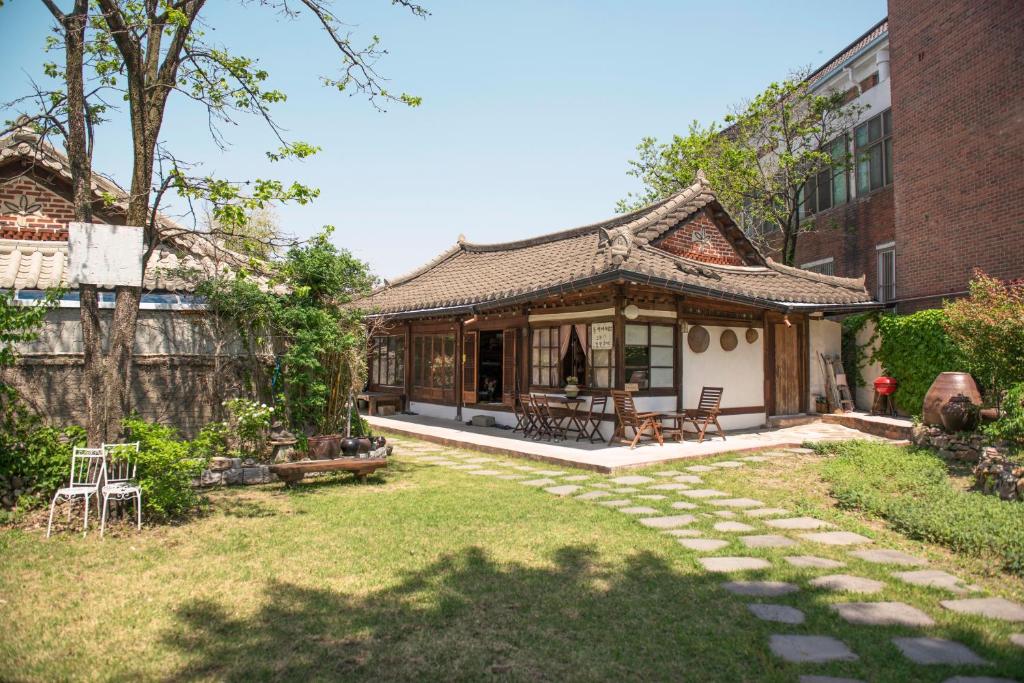a house with a garden in front of a building at Ginkgo Tree Guesthouse in Jeonju