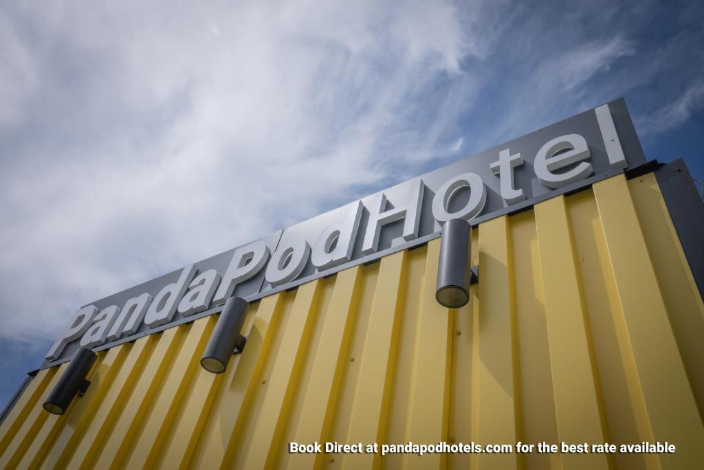 a sign on the side of a yellow building at Panda Pod Hotel in Richmond