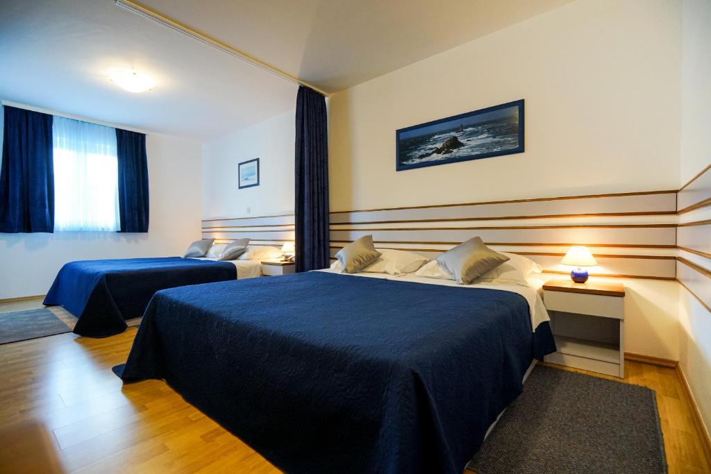 Posteľ alebo postele v izbe v ubytovaní Hotel Belvedere