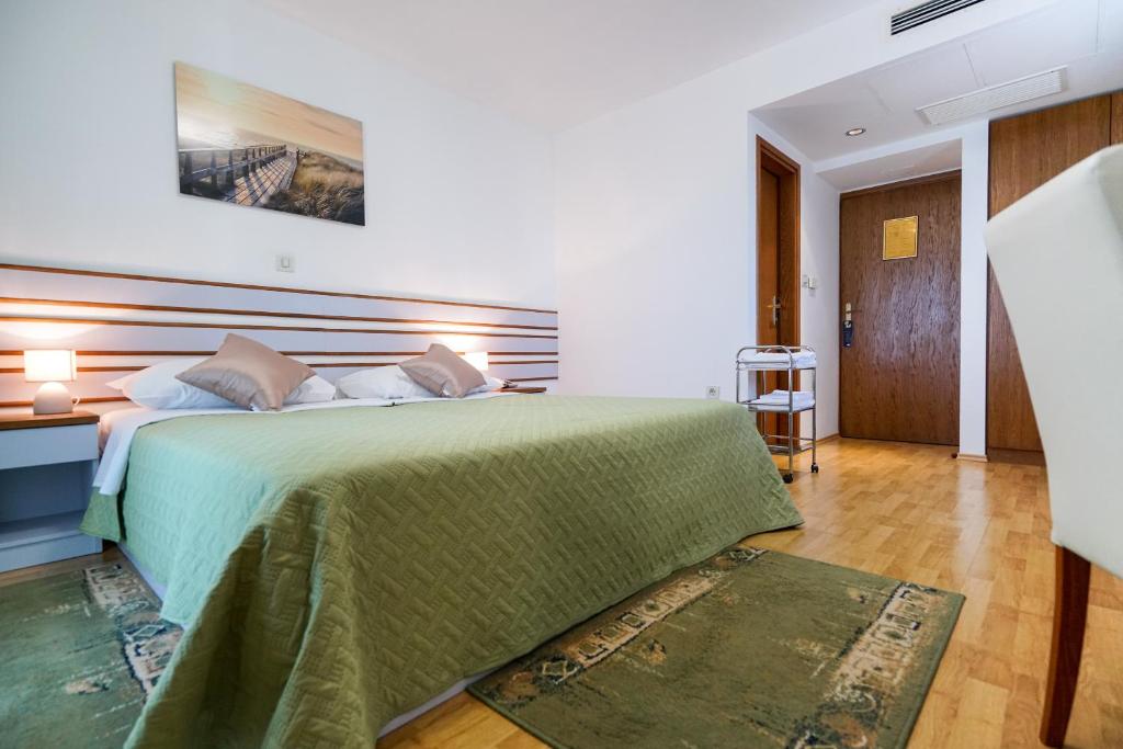 Posteľ alebo postele v izbe v ubytovaní Hotel Belvedere