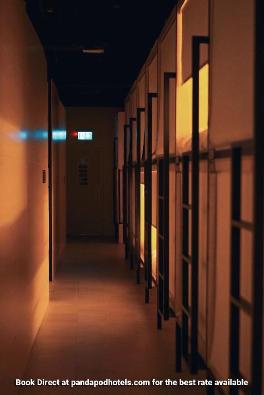 an empty hallway in a building with a light on at Panda Pod Hotel in Richmond