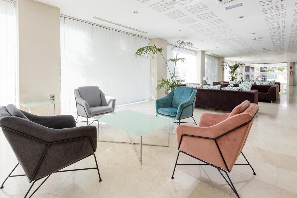 a lobby with chairs and a table and a couch at Daniya Alicante in Alicante