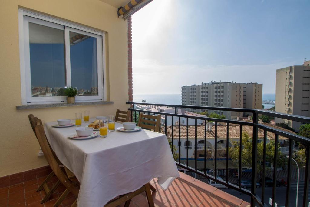 a table on a balcony with a view of the ocean at Santa Amalia 45 by IVI Real Estate in Torremolinos