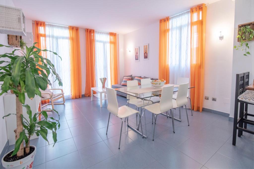 a dining room with a white table and chairs at Hogar Vera Apartments&Bikes in Valencia