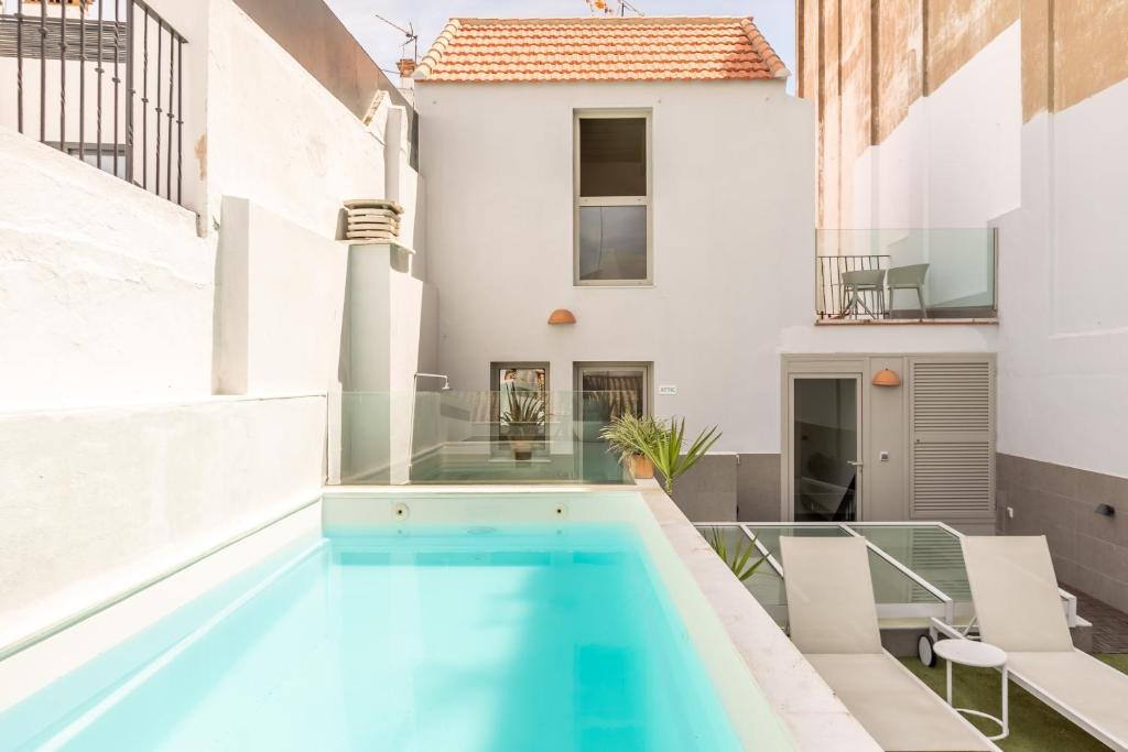 a swimming pool on the roof of a house at Kayser Premium Suites in Seville