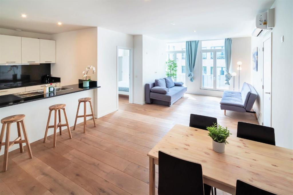 Il comprend une cuisine et un salon avec une table et des chaises. dans l'établissement The Central Square Residence, à Anvers
