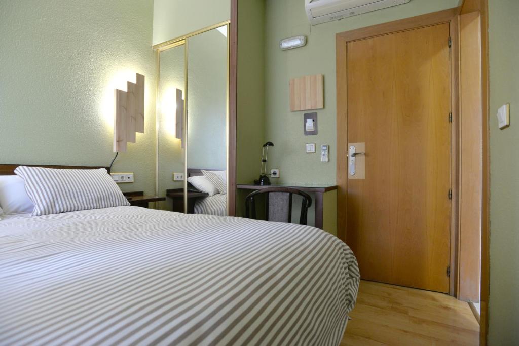 Postel nebo postele na pokoji v ubytování Hostal Concejo