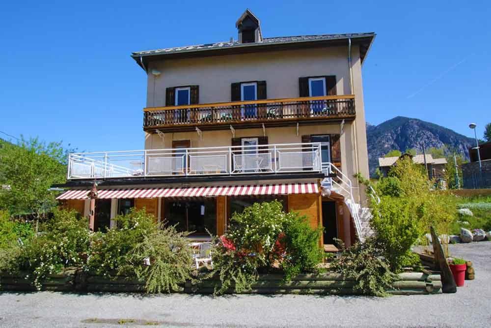 a large building with a balcony on top of it at Pension Saint Antoine in Briançon