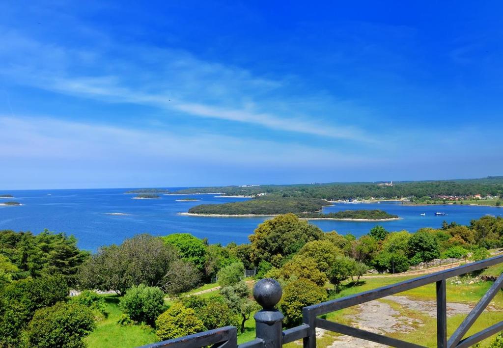 a view of a lake from a wooden railing at Villa Carla in Vrsar