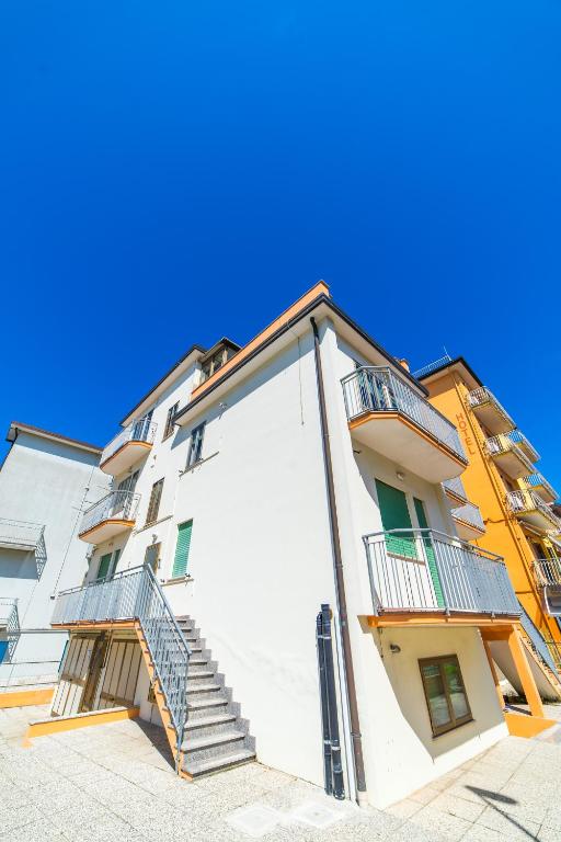 a white building with stairs on the side of it at Uliana Top House in Chioggia