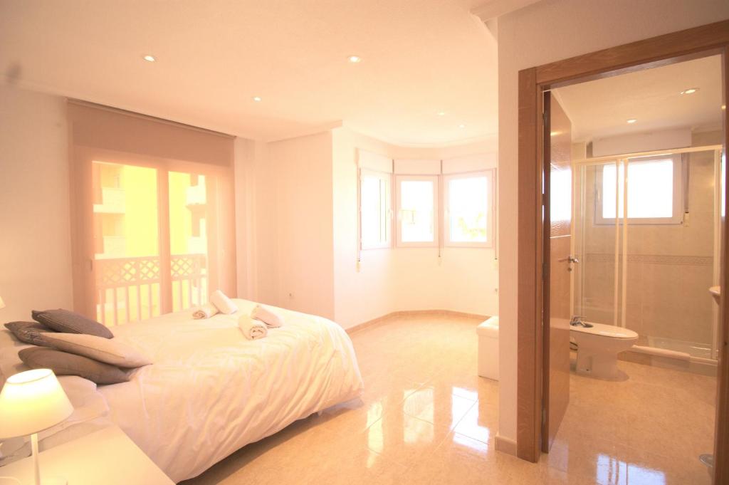 A bed or beds in a room at Spanish Connection - Playa Principe