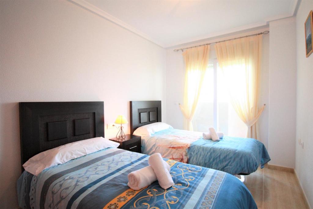 A bed or beds in a room at Spanish Connection - Seychelles