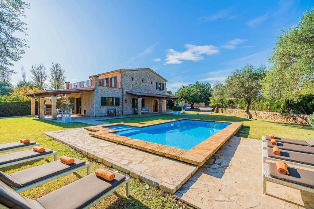 an estate with a swimming pool in front of a house at Villa Font Xica Petit by Sealand Villas in El Port