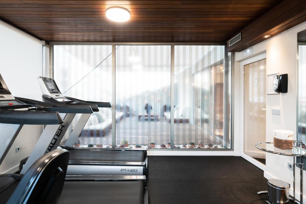 an office with a large window and a treadmill at Hospes Amérigo, Alicante, a Member of Design Hotels in Alicante