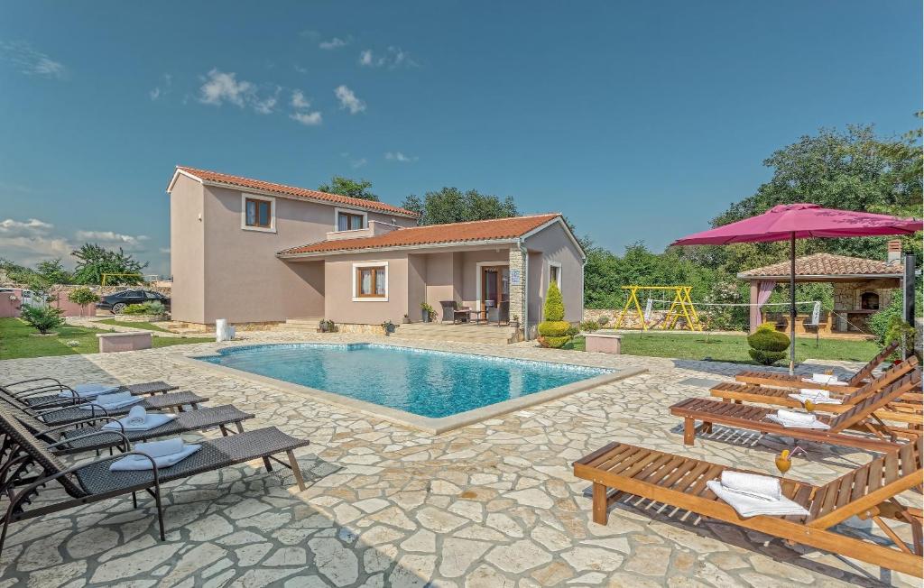 a villa with a swimming pool and a house at Villa Klaudia in Valtura