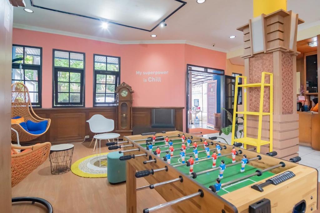 a play room with a table with a chessboard at Sans Hotel Cihampelas Bandung in Bandung