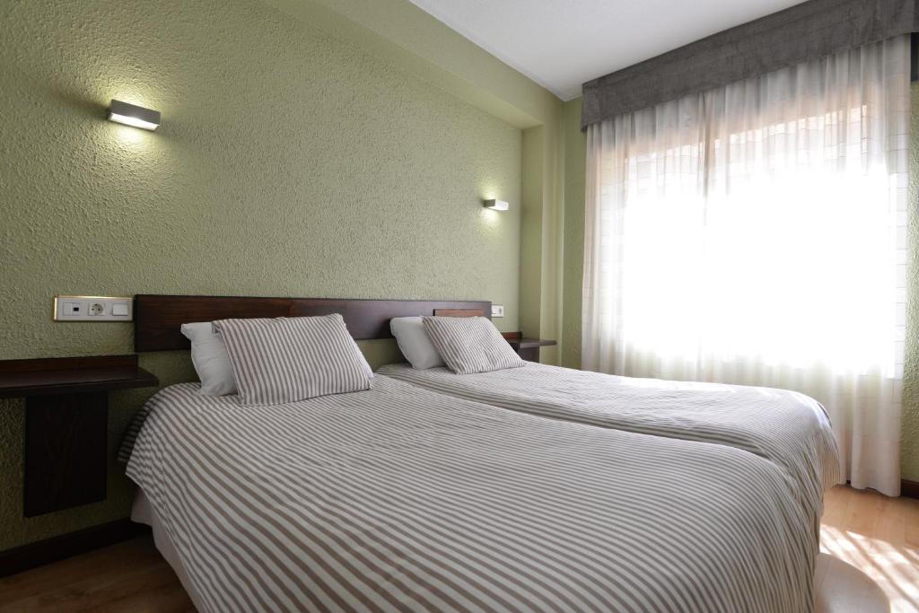Postel nebo postele na pokoji v ubytování Hostal Concejo