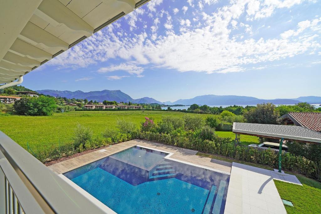 a swimming pool in the backyard of a house at Gardaliva 5 in Manerba del Garda