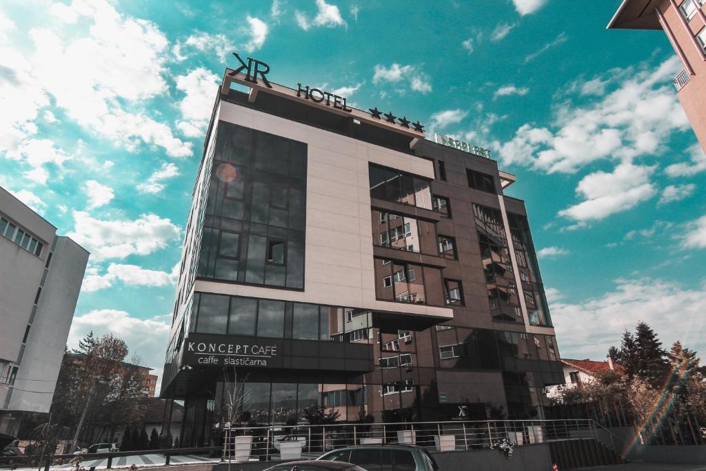 a tall building with a sign on top of it at Hotel Koncept Residence in Sarajevo