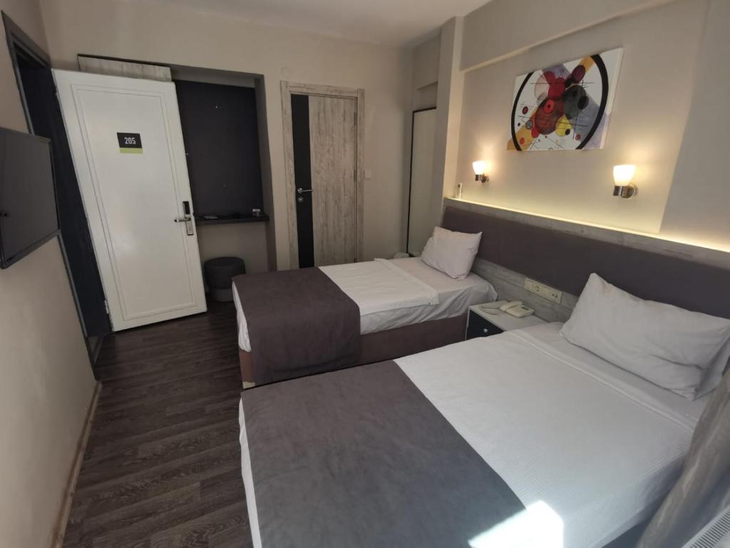 Postel nebo postele na pokoji v ubytování Temizay Hotel