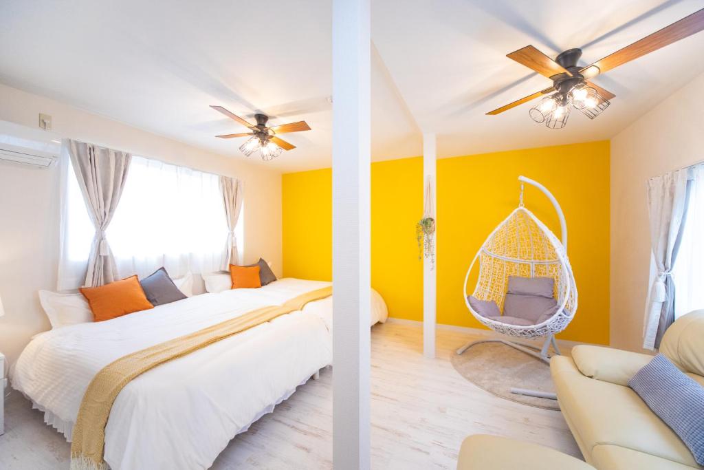 2 Bilder eines Schlafzimmers mit gelben Wänden in der Unterkunft Awaji egaosakuie tonouchi in Awaji
