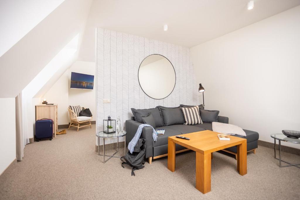 a living room with a couch and a table at maakt Apartments in Stralsund