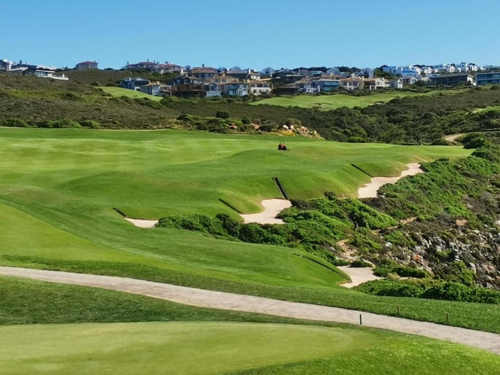 a view of a golf course with a green at Lodge 93 in Mossel Bay