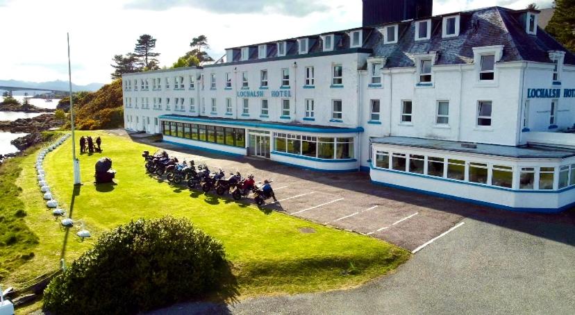 a group of people on horses in front of a building at Lochalsh Hotel with Views to the beautiful Isle of Skye in Kyle of Lochalsh
