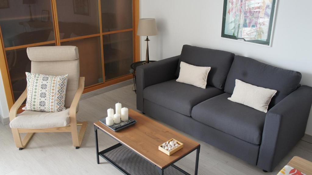 a living room with a couch and a coffee table at Apartamentos Calma Rentals in Torremolinos