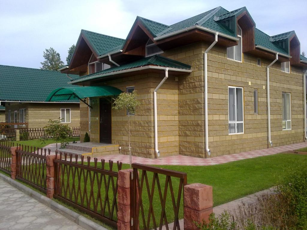 a house with a fence in front of it at Solnyshko Apartment VIP2 in Chok-Tal