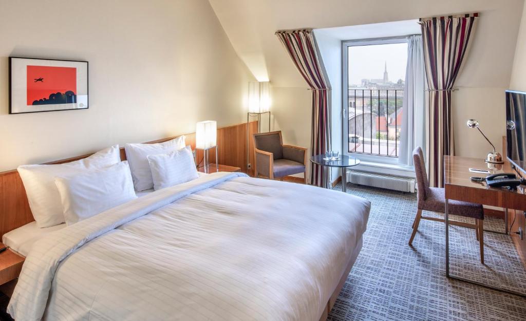 מיטה או מיטות בחדר ב-K+K Hotel Maria Theresia