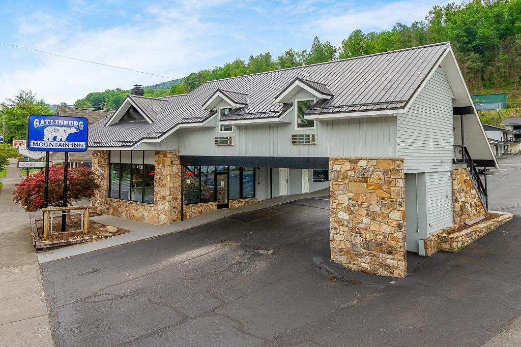 a large white building with a sign in front of it at Gatlinburg Mountain Inn in Gatlinburg