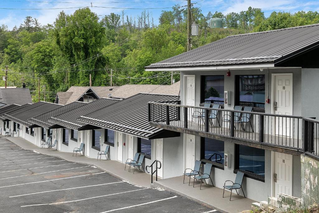 a row of buildings with chairs in a parking lot at Gatlinburg Mountain Inn in Gatlinburg