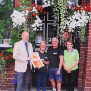 a group of people standing in front of a building at Kings Arms Hotel in Holsworthy